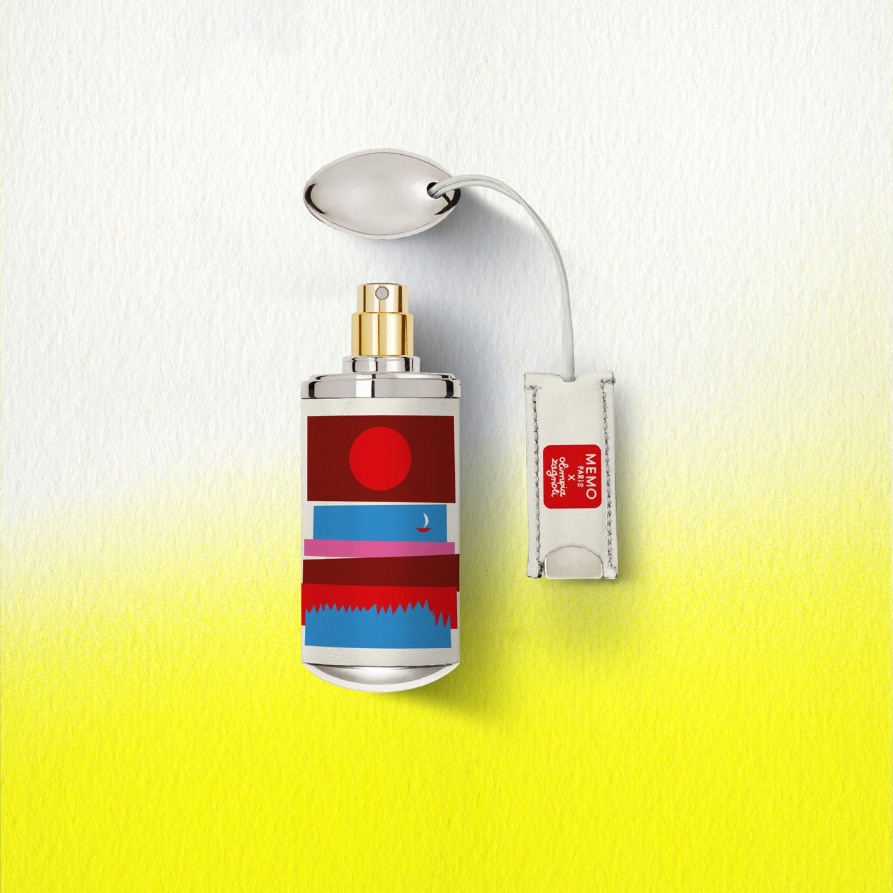 A sleek cylindrical cap camarat perfume bottle by memo paris with metallic cap and bold red blue white stripes