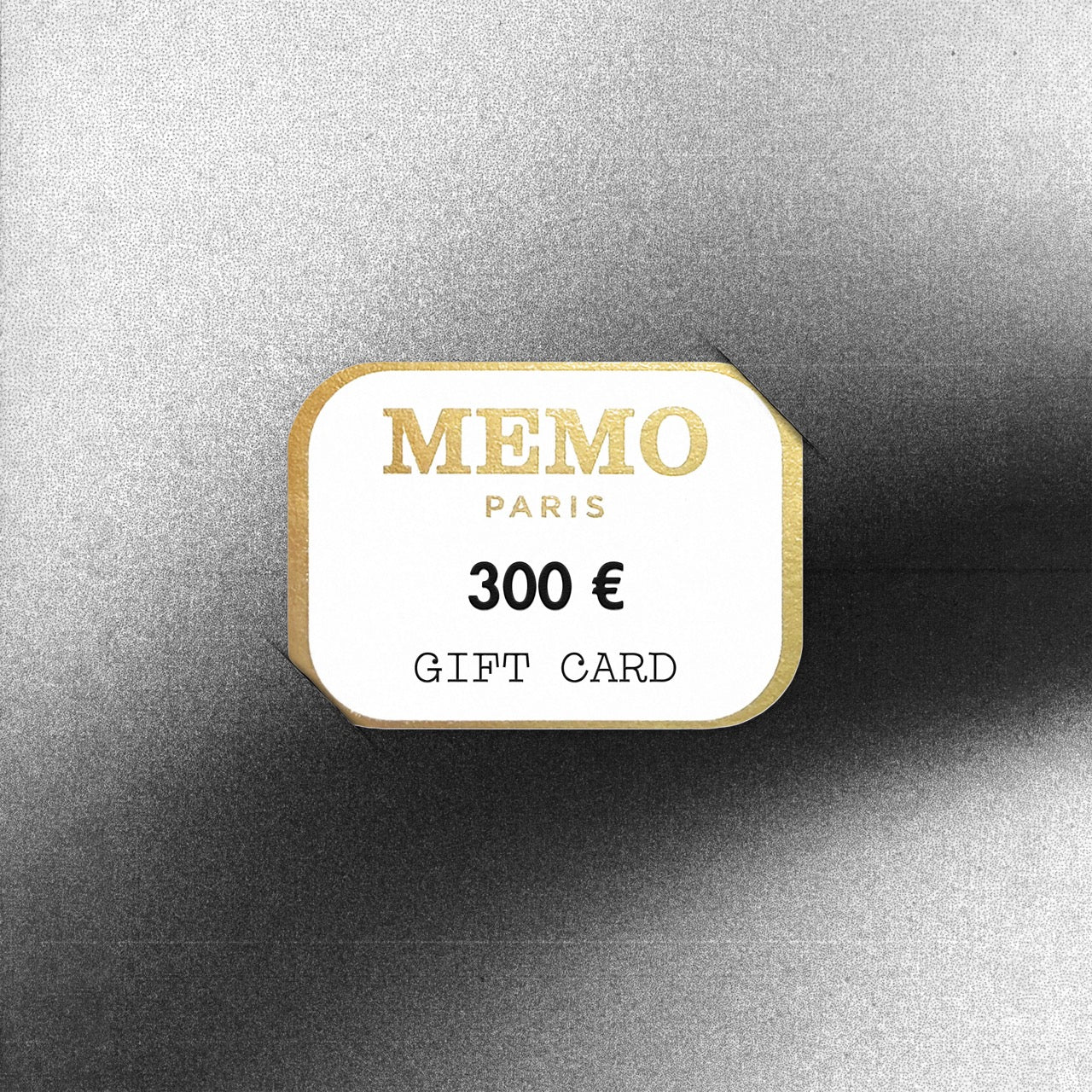 A white and gold memo paris gift card with 300 euro denomination celebrating dream destinations